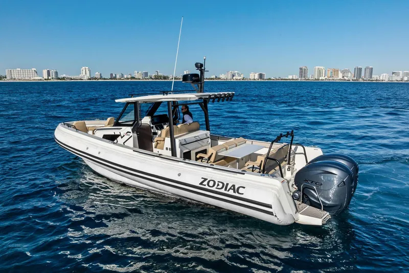 Slide: The Image of 2025 Zodiac X10CC boat cruising on blue ocean near city skyline. - 15