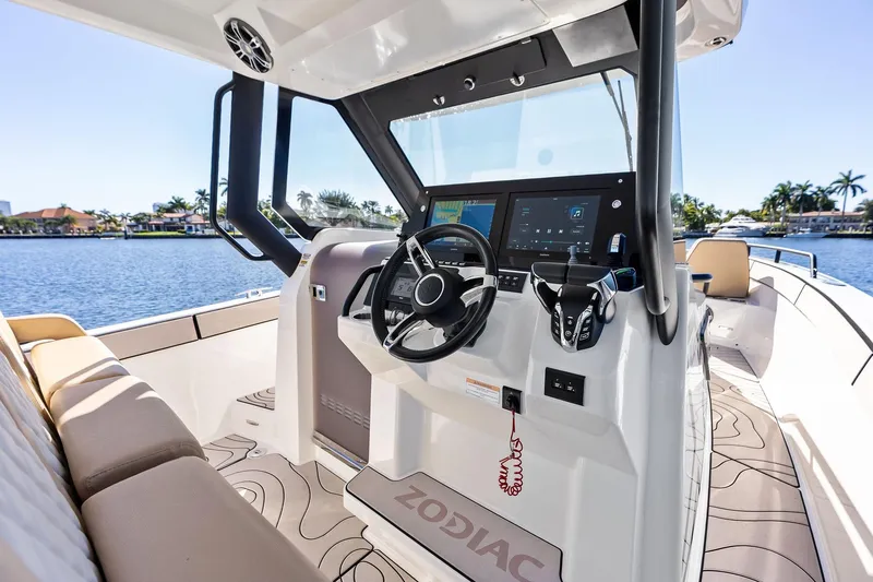 Slide: The Image of Modern Zodiac X10CC 2025 boat cockpit with advanced controls and scenic waterfront view. - 36