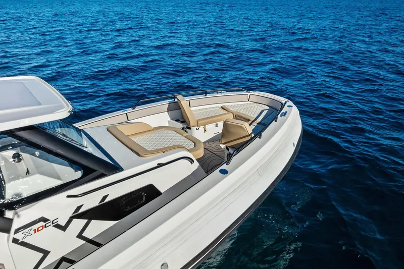 Slide: The Image of 2025 Zodiac X10CC boat on blue ocean water, featuring sleek design and comfortable seating. - 18