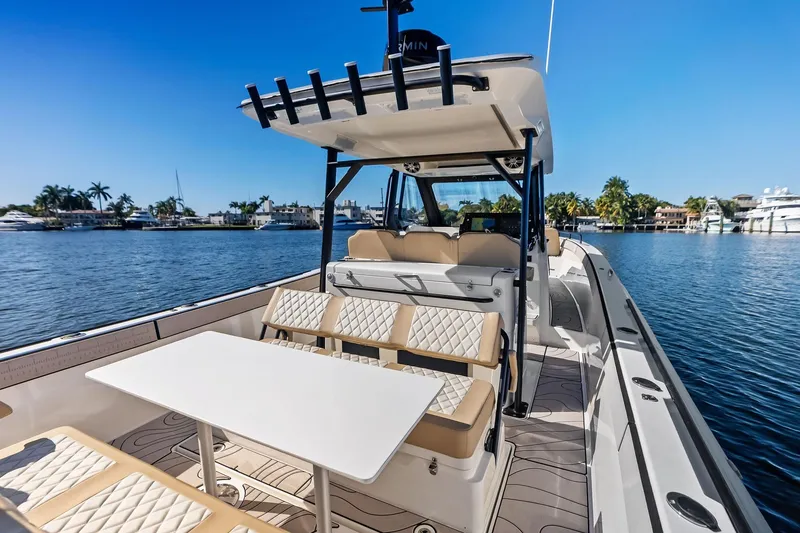 Slide: The Image of 2025 Zodiac X10CC boat interior with seating and table on a sunny day. - 26