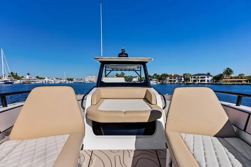Slide: The Image of 2025 Zodiac X10CC boat interior with beige seating, on a sunny waterfront. - 42