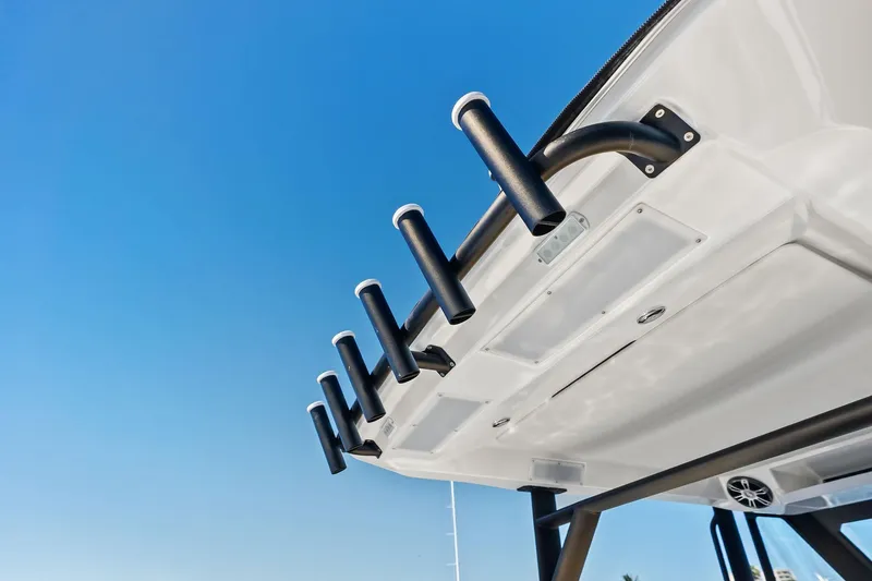 Slide: The Image of 2025 Zodiac X10CC boat with rod holders against clear blue sky. - 50