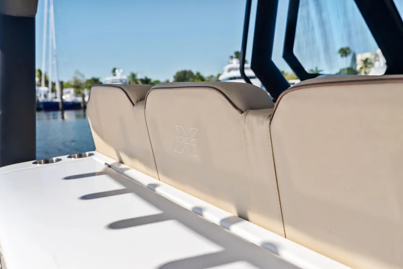 Slide: The Image of 2025 Zodiac X10CC boat seats with embossed logo, docked in a marina. - 34