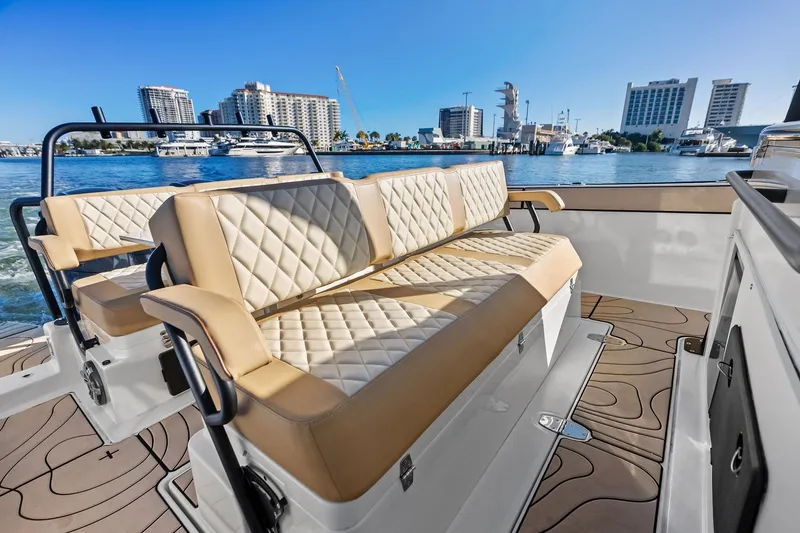 Slide: The Image of Luxurious seating on 2025 Zodiac X10CC boat with waterfront cityscape in background. - 29