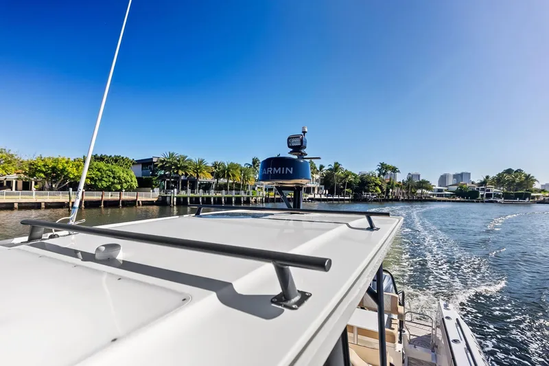 Slide: The Image of Zodiac X10CC 2025 boat cruising on a sunny waterfront with clear blue skies. - 51