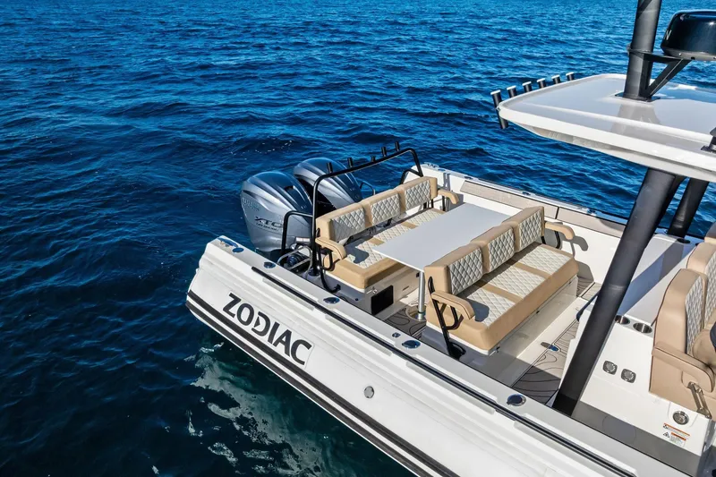Slide: The Image of 2025 Zodiac X10CC boat with seating and table on open water. - 19