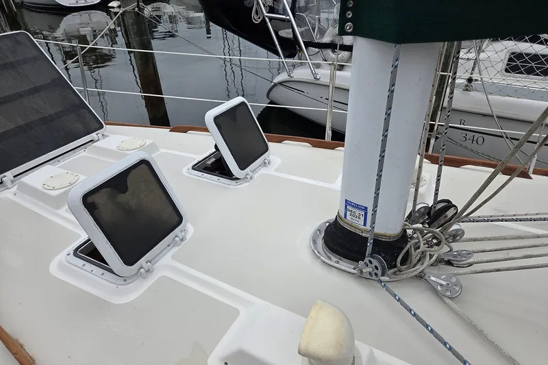 Slide: The Image of 1983 Sabre 38 sailboat deck with open hatches and rigging details. - 7