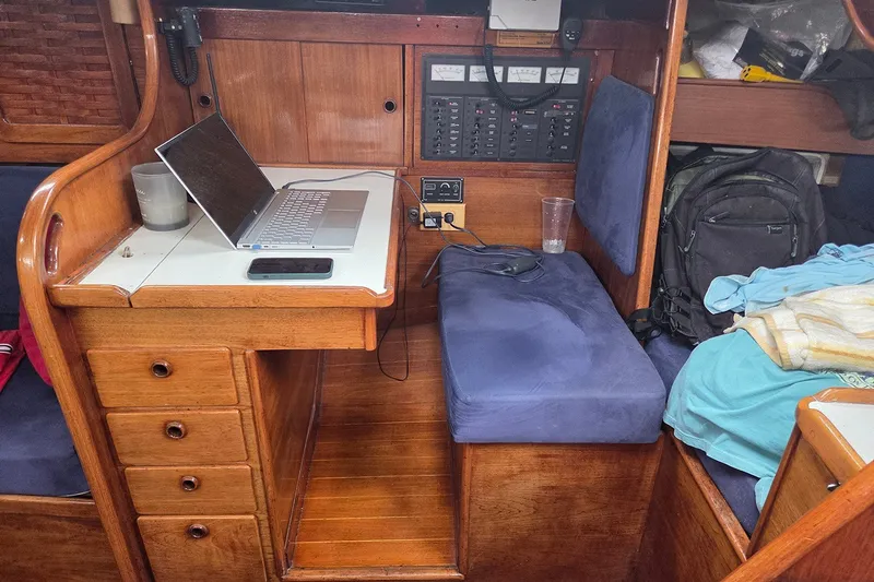Slide: The Image of Interior of a 1983 Sabre 38 sailboat with a navigation station and laptop. - 21