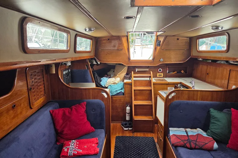 Slide: The Image of Cozy interior of a 1983 Sabre 38 sailboat with wooden finishes and seating. - 19