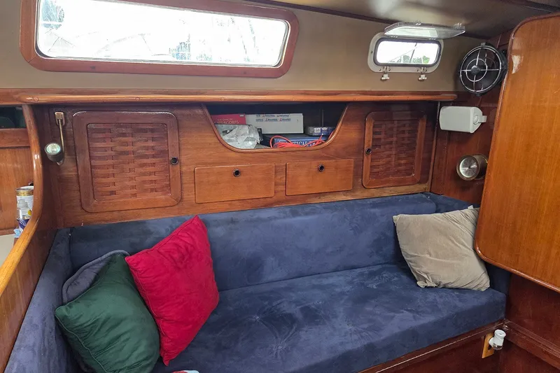 Slide: The Image of Cozy interior of 1983 Sabre 38 sailboat with wooden cabinetry and colorful cushions. - 23