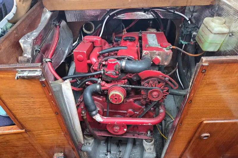 Slide: The Image of Engine compartment of a 1983 Sabre 38 sailboat, featuring a red marine engine. - 25
