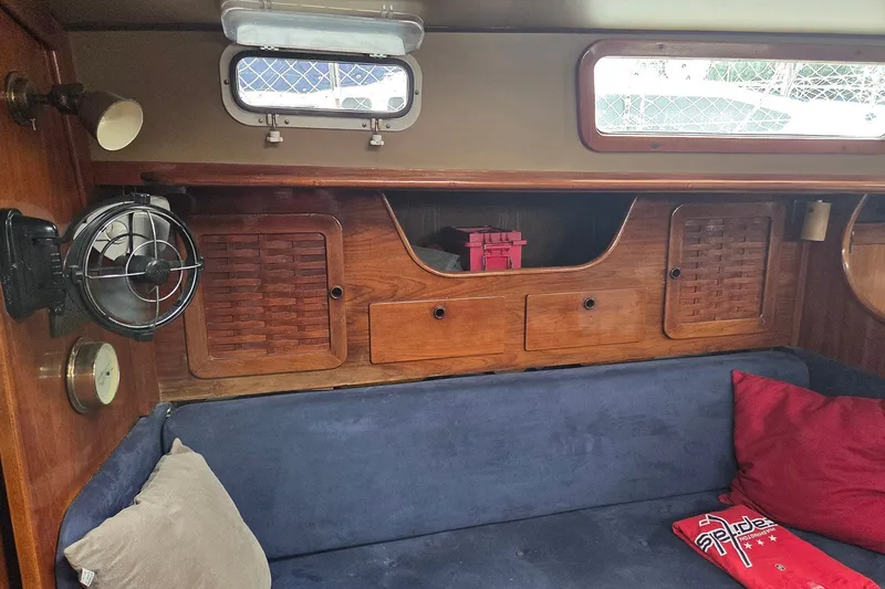 Slide: The Image of Interior of 1983 Sabre 38 sailboat with wooden cabinetry and blue seating. - 24