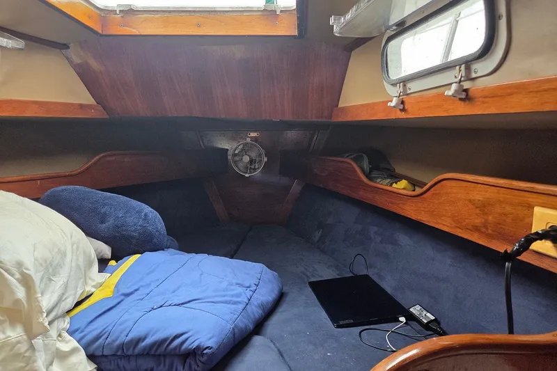 Slide: The Image of Cozy cabin interior of 1983 Sabre 38 sailboat with bedding and porthole. - 18