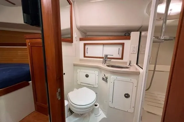 Slide: The Image of 2008 Back Cove 33 yacht bathroom with sink, toilet, and shower. - 17