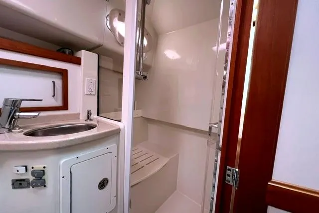 Slide: The Image of 2008 Back Cove 33 yacht bathroom with sink, shower, and wooden accents. - 18
