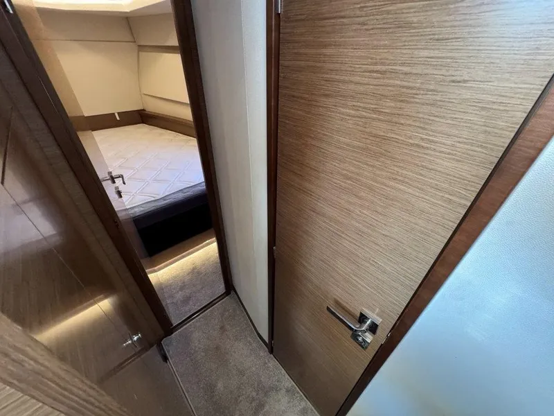 Slide: The Image of Interior of a 2016 Fountaine Pajot Motor Yacht 37 with wooden doors and a bedroom. - 31