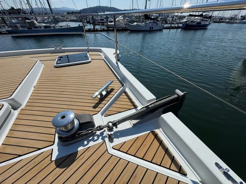 Slide: The Image of The deck of a 2016 Fountaine Pajot Motor Yacht 37 with anchor and winch in a marina. - 40