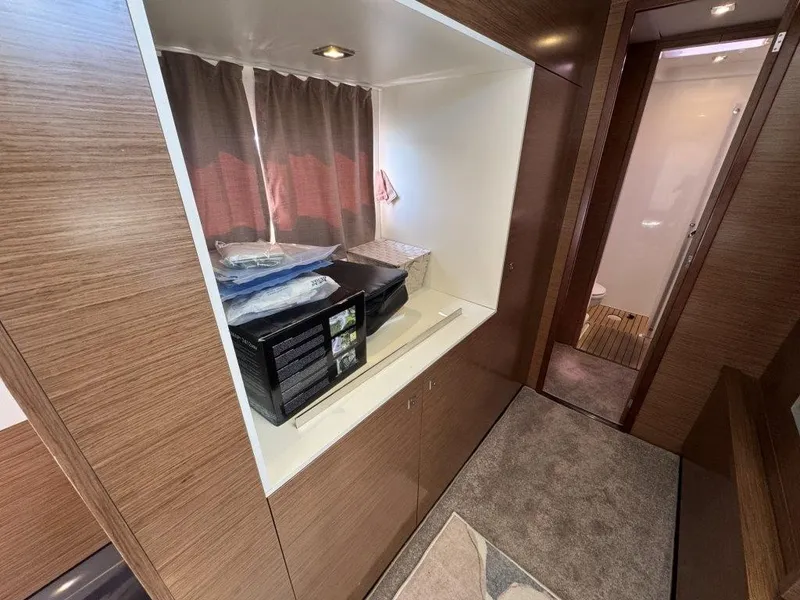 Slide: The Image of Interior of a 2016 Fountaine Pajot Motor Yacht 37 with wood paneling and carpeted floor. - 25