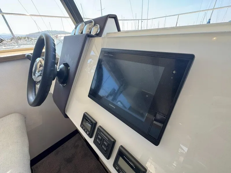 Slide: The Image of The image shows the helm of a 2016 Fountaine Pajot Motor Yacht 37. - 16