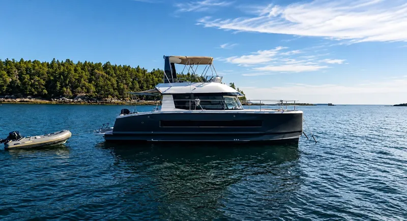 The Image of 2016 Fountaine Pajot Motor Yacht 37 on calm water, surrounded by trees. - 0