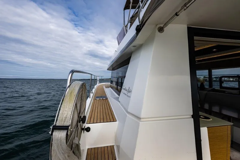 Slide: The Image of The 2016 Fountaine Pajot Motor Yacht 37 cruises on calm waters, showcasing a sleek, modern design. - 7