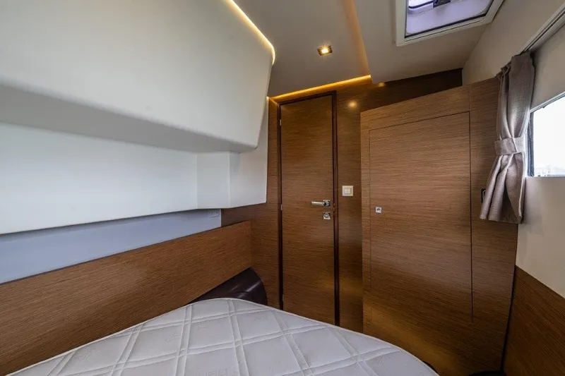 Slide: The Image of Interior of a 2016 Fountaine Pajot Motor Yacht 37 with wood paneling and a window. - 28
