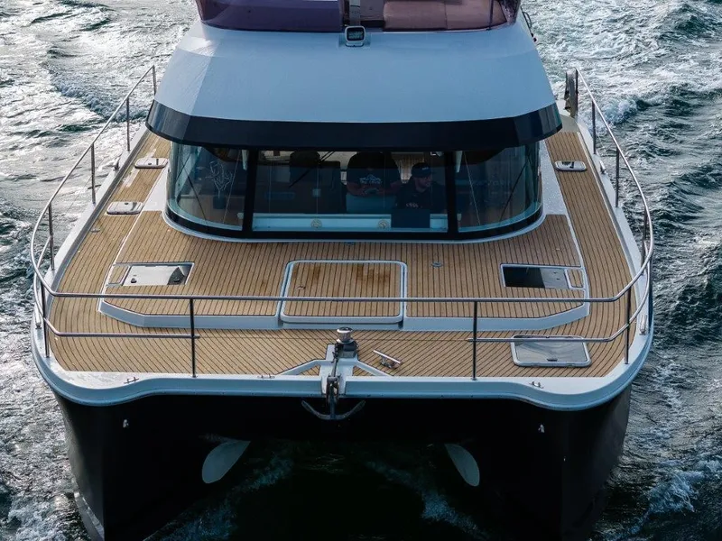 Slide: The Image of The 2016 Fountaine Pajot Motor Yacht 37 cruising on water, featuring a spacious deck. - 5