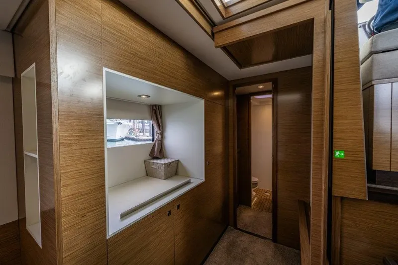 Slide: The Image of Interior of a 2016 Fountaine Pajot Motor Yacht 37 with wood paneling and a small window. - 31