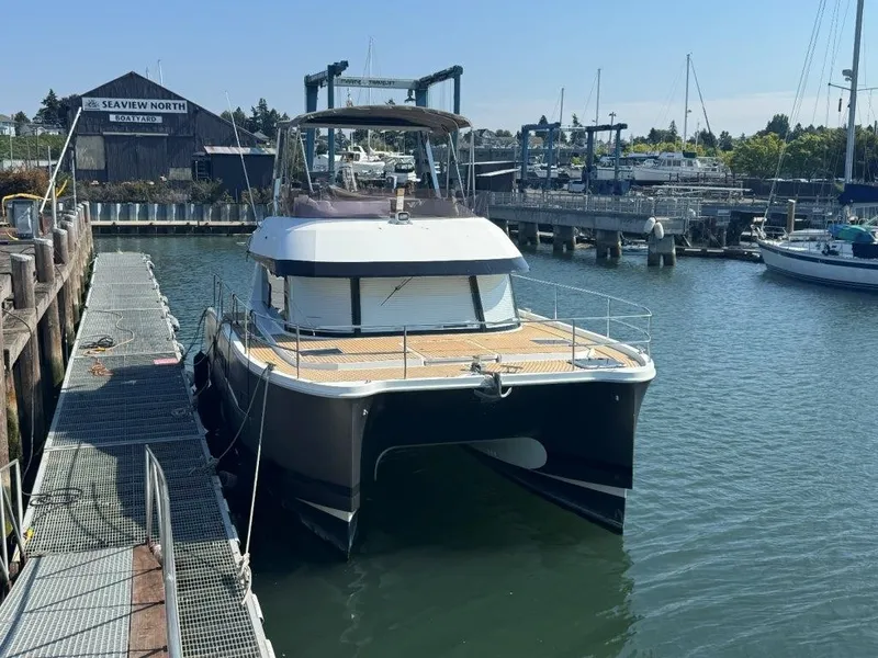 Slide: The Image of A 2016 Fountaine Pajot Motor Yacht 37 docked at a harbor, surrounded by other boats. - 1