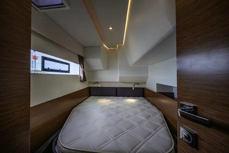 Slide: The Image of The cabin of a 2016 Fountaine Pajot Motor Yacht 37 with a large bed and modern design. - 24