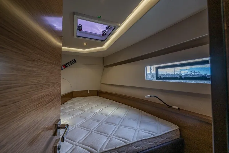 Slide: The Image of The cabin of a 2016 Fountaine Pajot Motor Yacht 37 with a large bed and a window. - 22