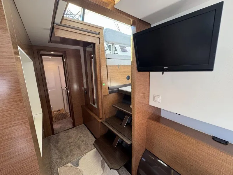 Slide: The Image of Interior of a 2016 Fountaine Pajot Motor Yacht 37 with wood paneling and a flat-screen TV. - 24