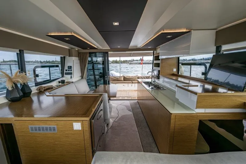 Slide: The Image of Interior of a modern yacht with sleek wood finishes and large windows overlooking the water. - 16