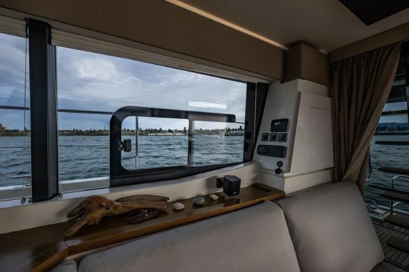 Slide: The Image of Interior view of a 2016 Fountaine Pajot Motor Yacht 37, showing water through a large window. - 19
