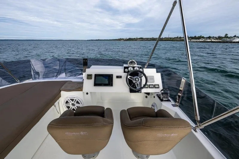 Slide: The Image of The image shows the helm of a 2016 Fountaine Pajot Motor Yacht 37 with two brown seats. - 9