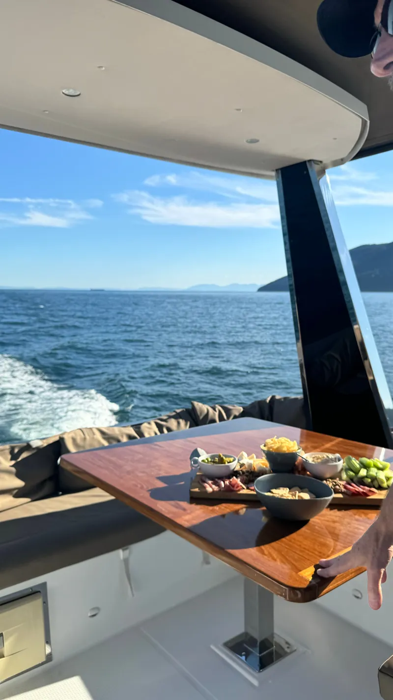 Slide: The Image of A luxurious table on a 2016 Fountaine Pajot Motor Yacht 37, with snacks and a sea view. - 3