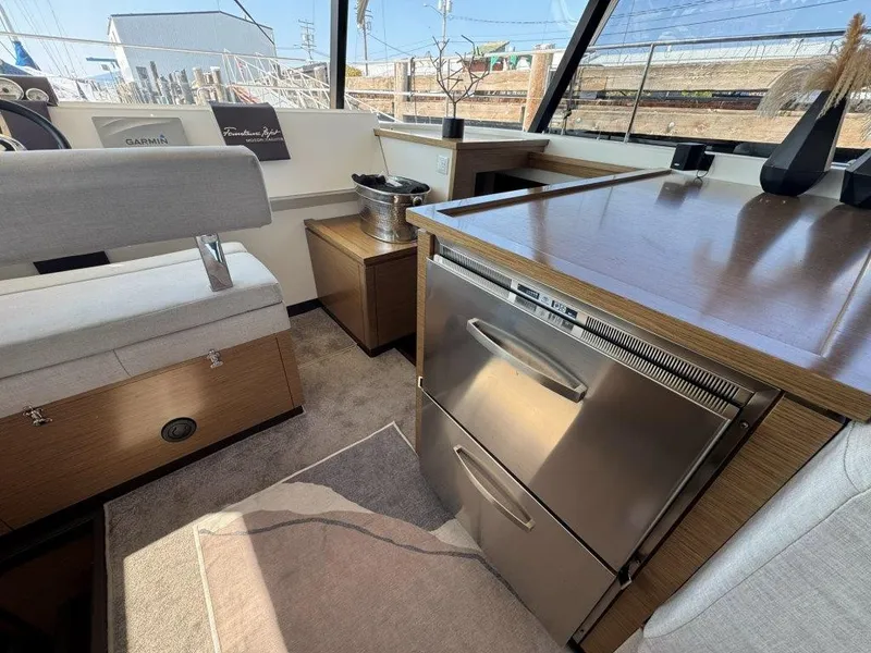 Slide: The Image of Interior of a 2016 Fountaine Pajot Motor Yacht 37 with modern kitchen and seating area. - 9