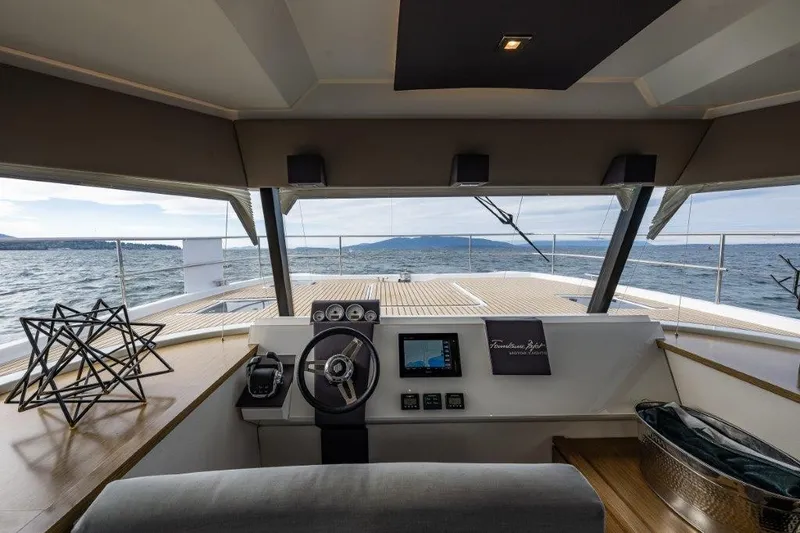 Slide: The Image of The cockpit of a 2016 Fountaine Pajot Motor Yacht 37 with a modern helm and sea view. - 15
