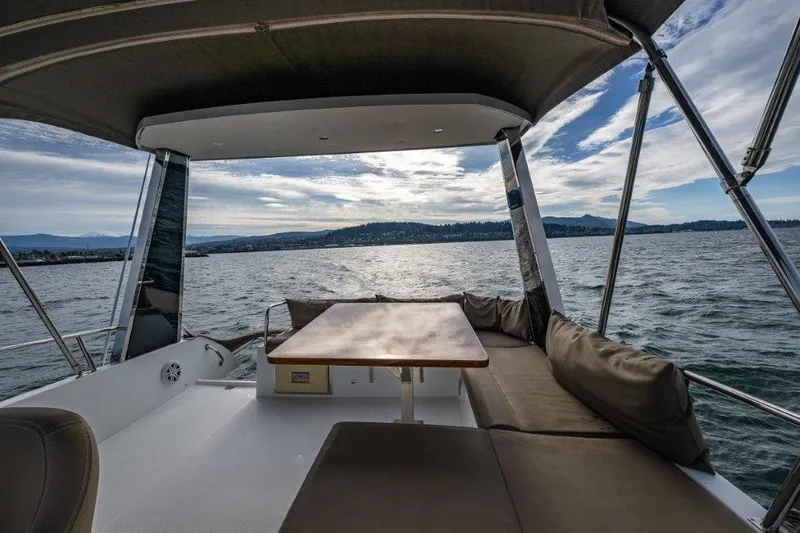 Slide: The Image of The image shows the aft deck of a 2016 Fountaine Pajot Motor Yacht 37 with seating and a table. - 10