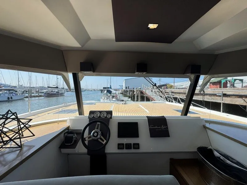 Slide: The Image of The cockpit of a 2016 Fountaine Pajot Motor Yacht 37 features a modern helm with a harbor view. - 14