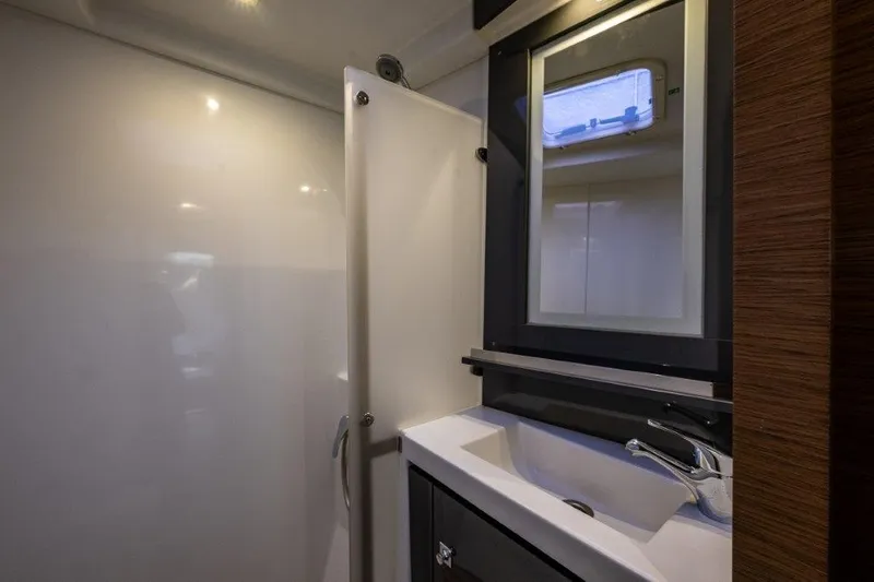 Slide: The Image of The image shows a modern yacht bathroom with a sink, mirror, and shower. - 34