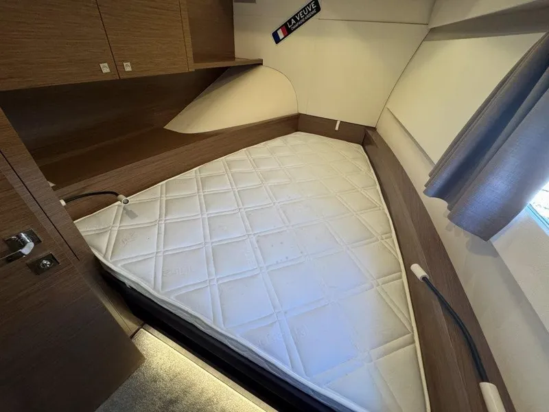 Slide: The Image of The cabin of a 2016 Fountaine Pajot Motor Yacht 37 with a large white bed. - 35