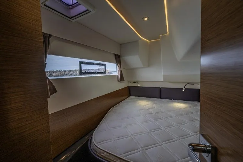 Slide: The Image of Cabin of the 2016 Fountaine Pajot Motor Yacht 37 with a large bed and window. - 25