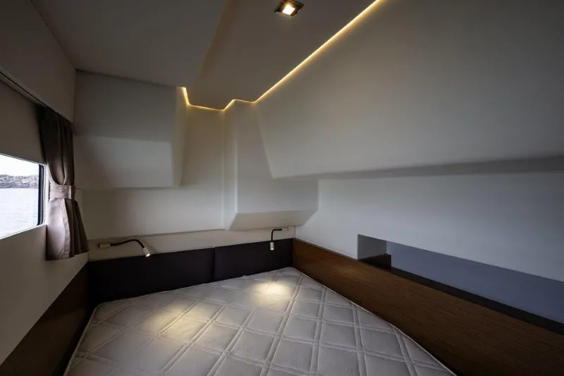 Slide: The Image of Interior of a modern yacht cabin with a large bed and stylish lighting. - 27