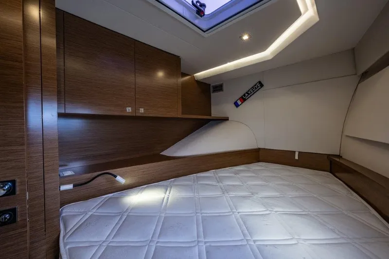 Slide: The Image of Interior of a 2016 Fountaine Pajot Motor Yacht 37 featuring a cozy sleeping area and wood paneling. - 23