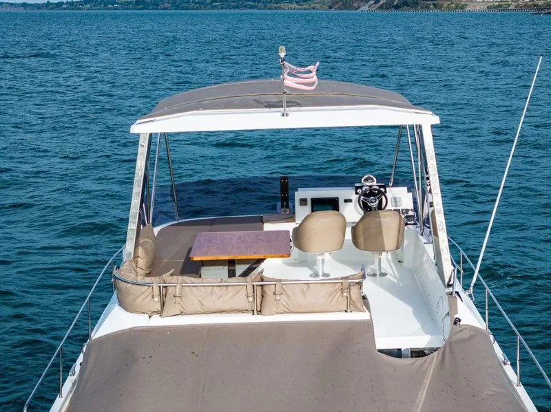 Slide: The Image of The image shows the deck of a 2016 Fountaine Pajot Motor Yacht 37 on the water. - 4