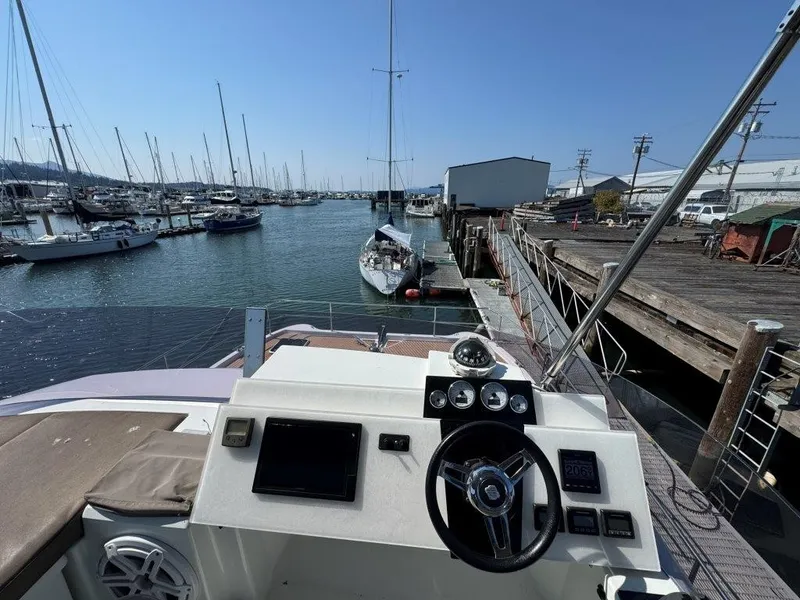 Slide: The Image of The cockpit of a 2016 Fountaine Pajot Motor Yacht 37 overlooking a marina. - 47