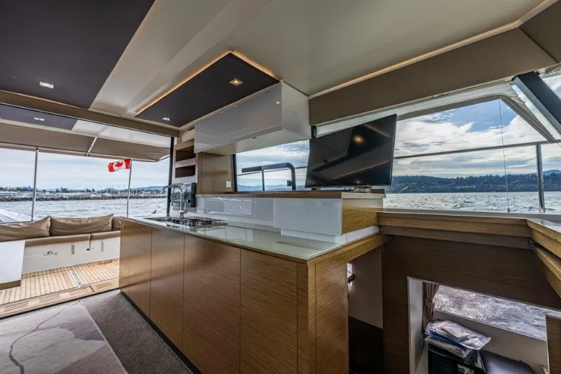 Slide: The Image of Interior of a modern yacht with sleek kitchen and large windows overlooking the water. - 18
