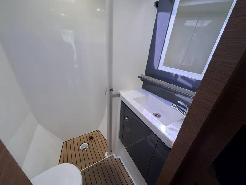 Slide: The Image of The image shows a modern yacht bathroom with a sink, mirror, and wooden floor. - 29