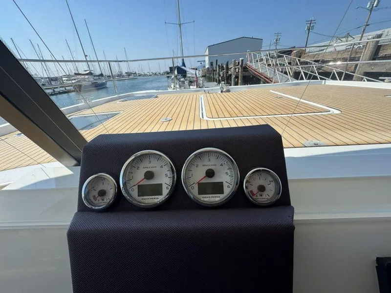 Slide: The Image of The image shows the dashboard of a 2016 Fountaine Pajot Motor Yacht 37 with a view of the marina. - 19